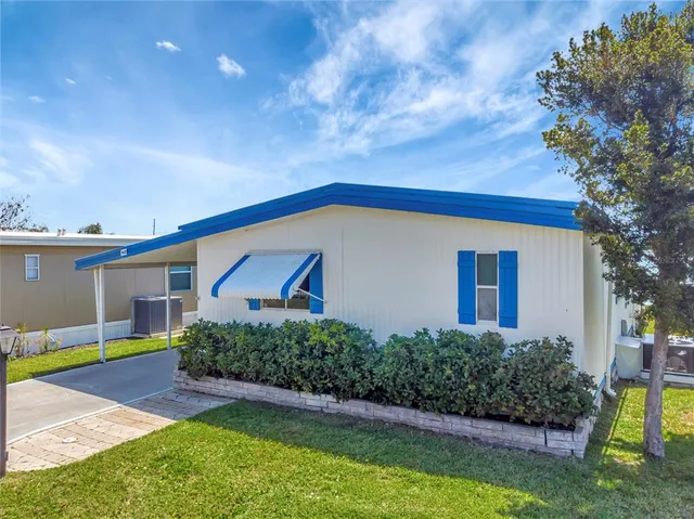 a spacious bedroom with a bed and a table chair