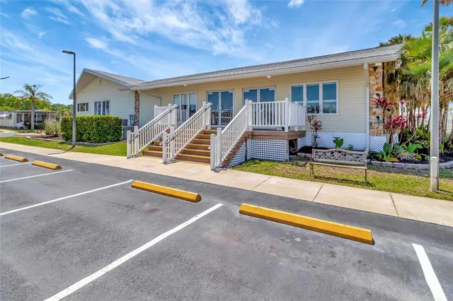 a living room with couches a dining table and chairs with wooden floor