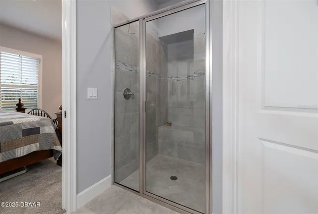 a bedroom with two beds and a lamp