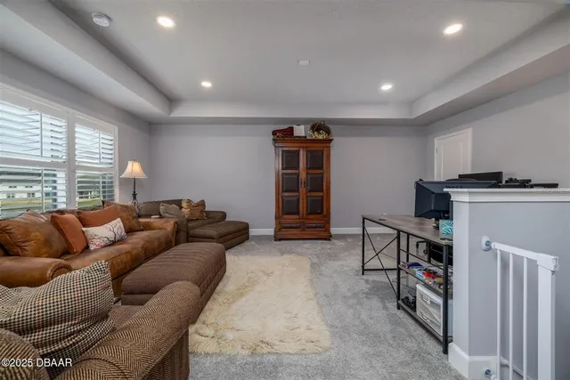 a living room with furniture a large window and a bookshelf