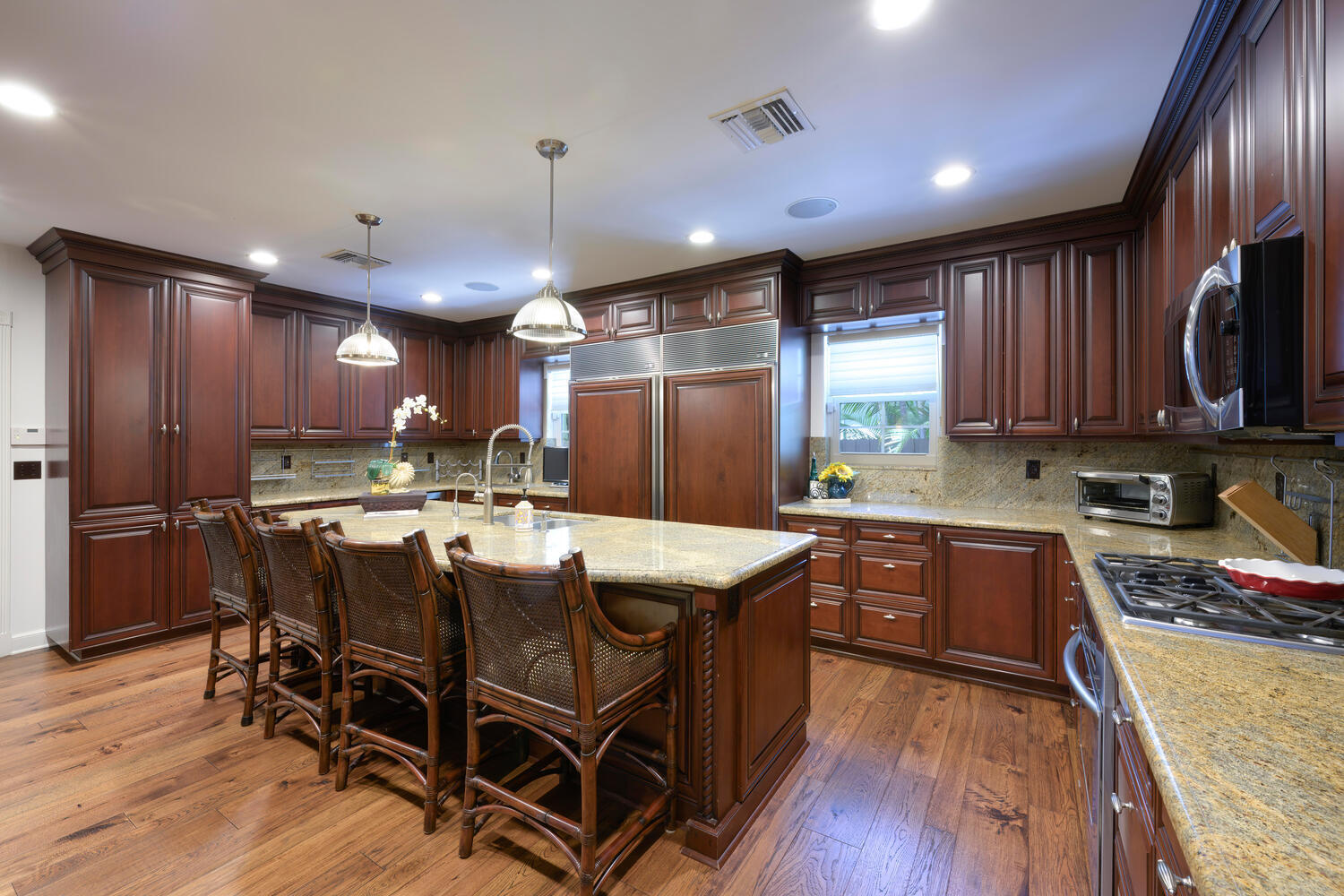 1125 Harbor Drive Delray Beach, FL 33483 - Photo 24 of 41 a kitchen with stainless steel appliances granite countertop wooden floors stove and microwave
