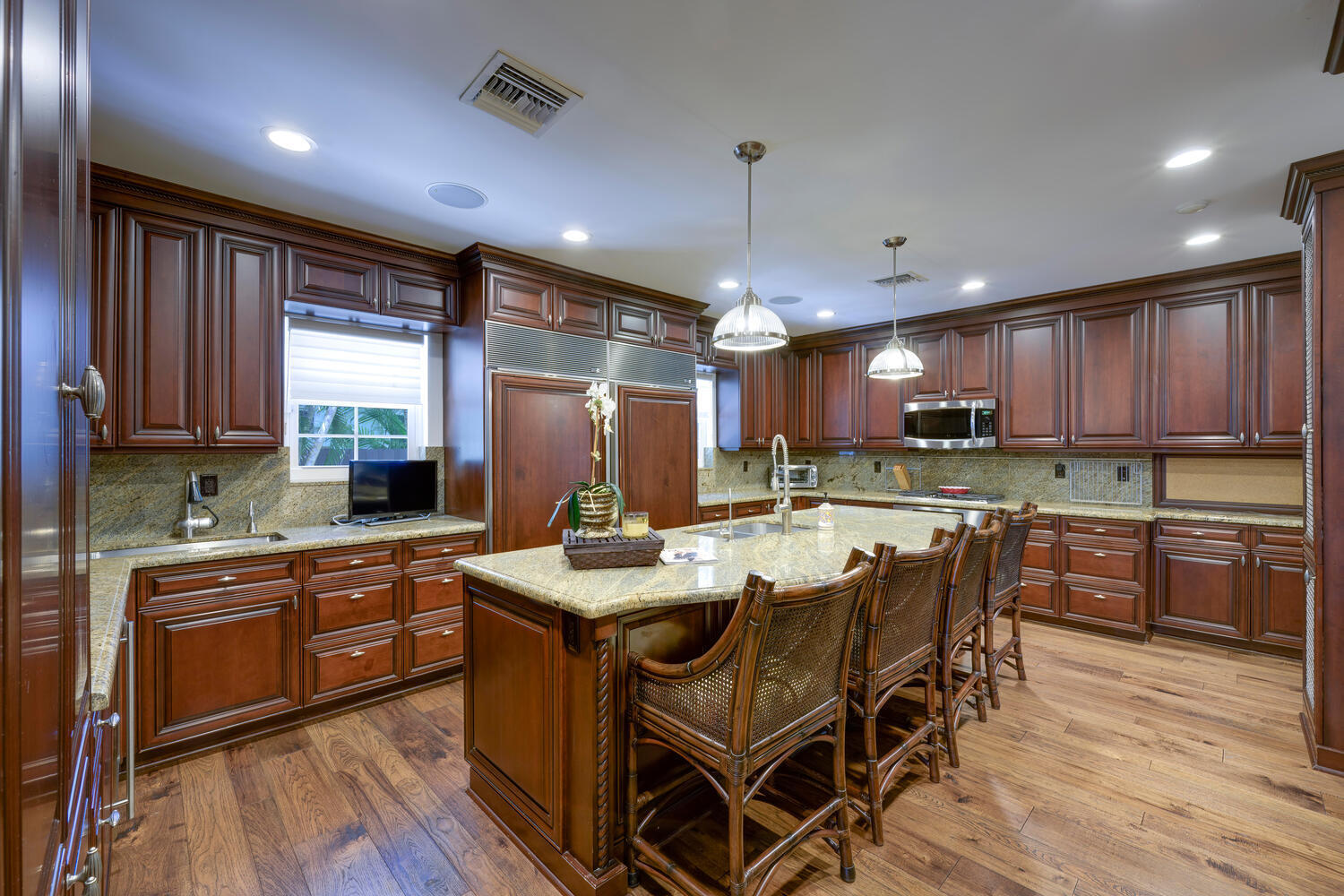 1125 Harbor Drive Delray Beach, FL 33483 - Photo 25 of 41 a kitchen with stainless steel appliances granite countertop wooden floors stove refrigerator and cabinets