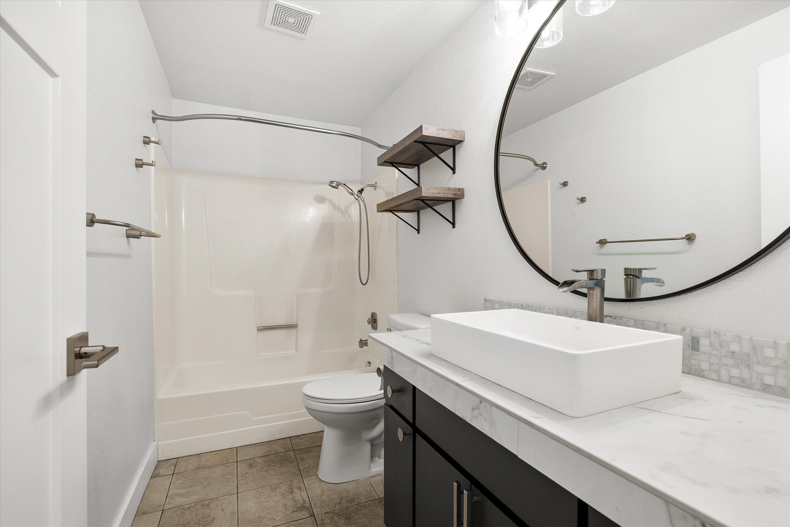 63634 Hunters Circle Bend, OR 97701 - Photo 17 of 28 a bathroom with a sink a toilet and shower