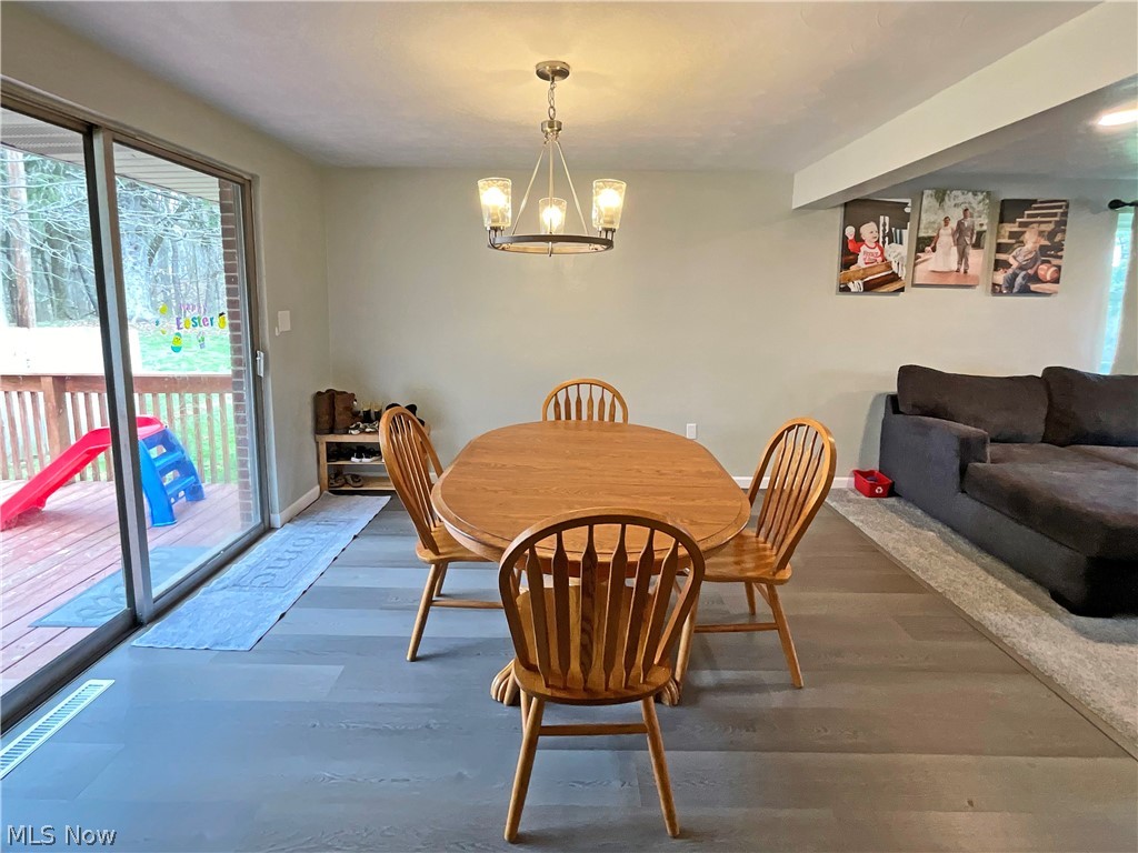 5637 Wylie Ridge Road New Cumberland, WV 26047 - Photo 5 of 21 Dining room featuring a notable chandelier and dark hardwood / wood-style floors