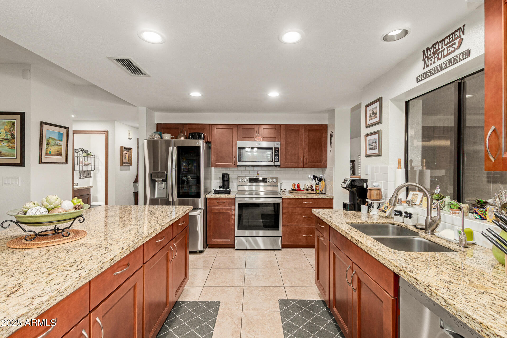 6231 West Grandview Road Glendale, AZ 85306 - Photo 13 of 35 a large kitchen with stainless steel appliances granite countertop a sink stove and refrigerator
