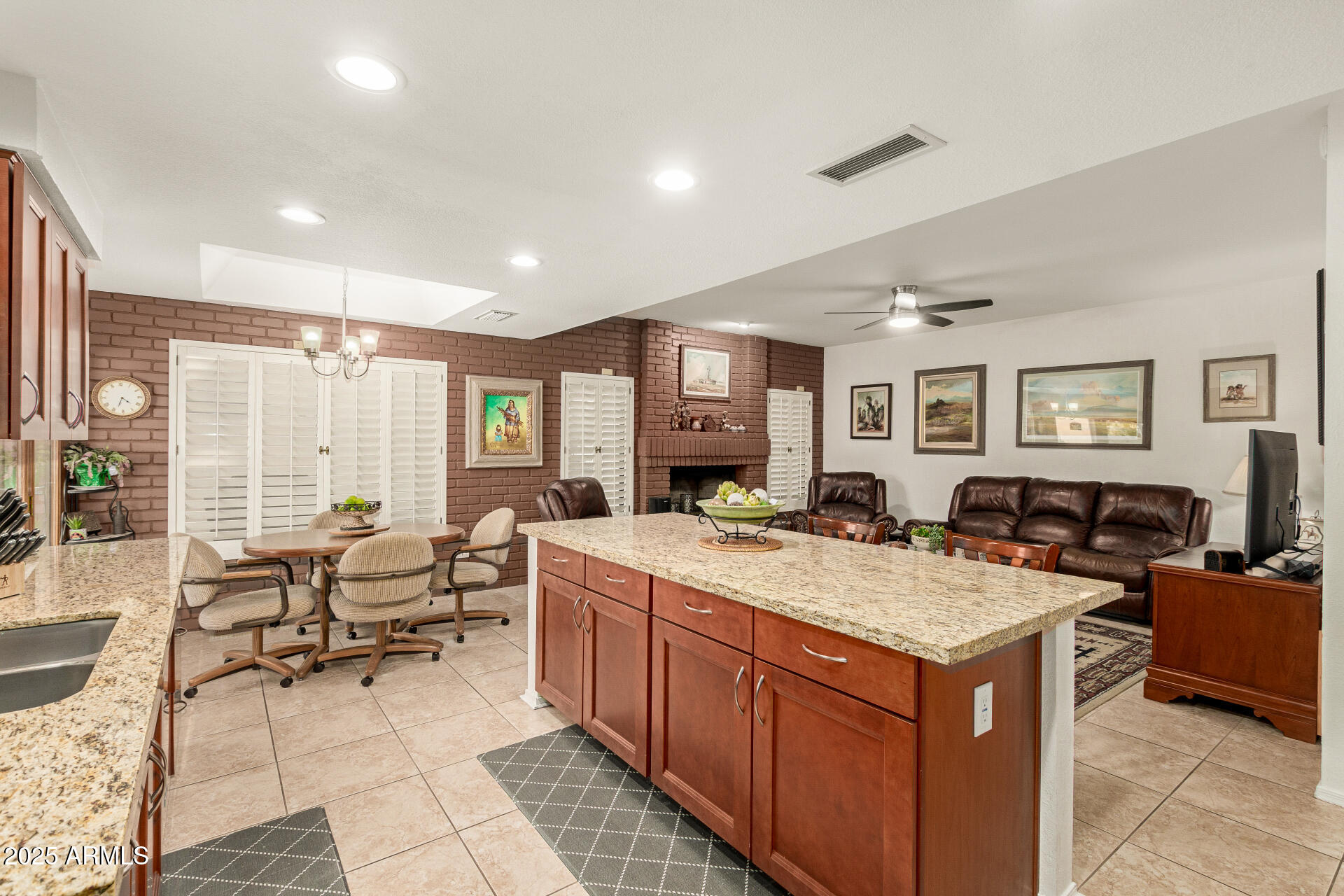 6231 West Grandview Road Glendale, AZ 85306 - Photo 15 of 35 a view of living room with granite countertop furniture and fireplace