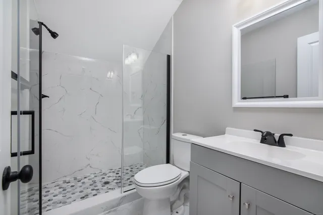 a bathroom with a sink toilet and vanity