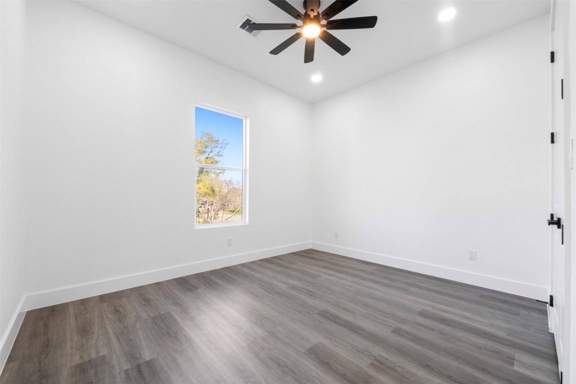 1304 Duff Lane Houston, TX 77022 - Photo 24 of 33 an empty room with wooden floor and windows