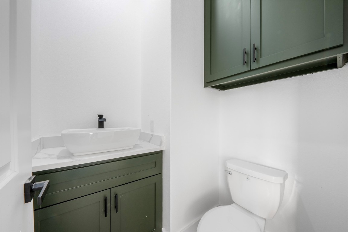 1304 Duff Lane Houston, TX 77022 - Photo 4 of 33 a bathroom with a toilet sink and mirror