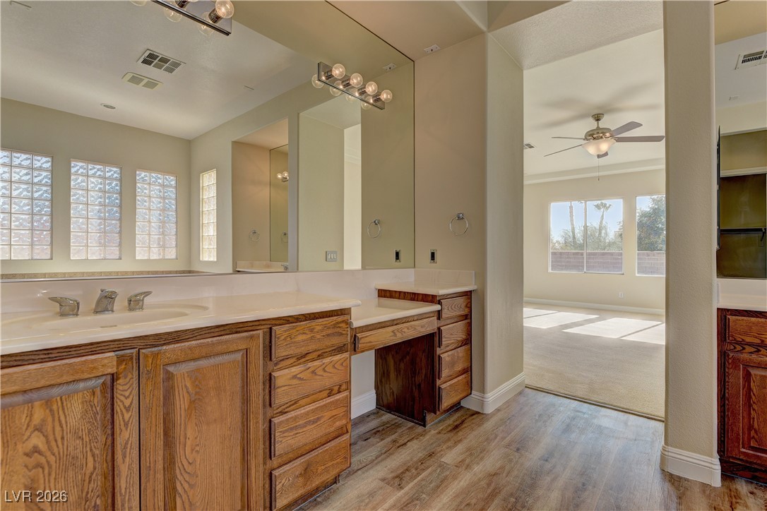 6383 Radiant Rapture Avenue Las Vegas, NV 89131 - Photo 11 of 17 Bathroom featuring vanity, light wood finished floors, and a ceiling fan