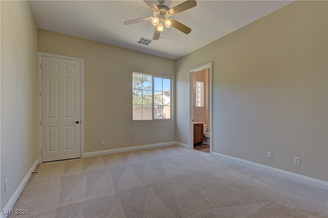 6383 Radiant Rapture Avenue Las Vegas, NV 89131 - Photo 14 of 17 Unfurnished bedroom with light carpet, ensuite bath, and ceiling fan