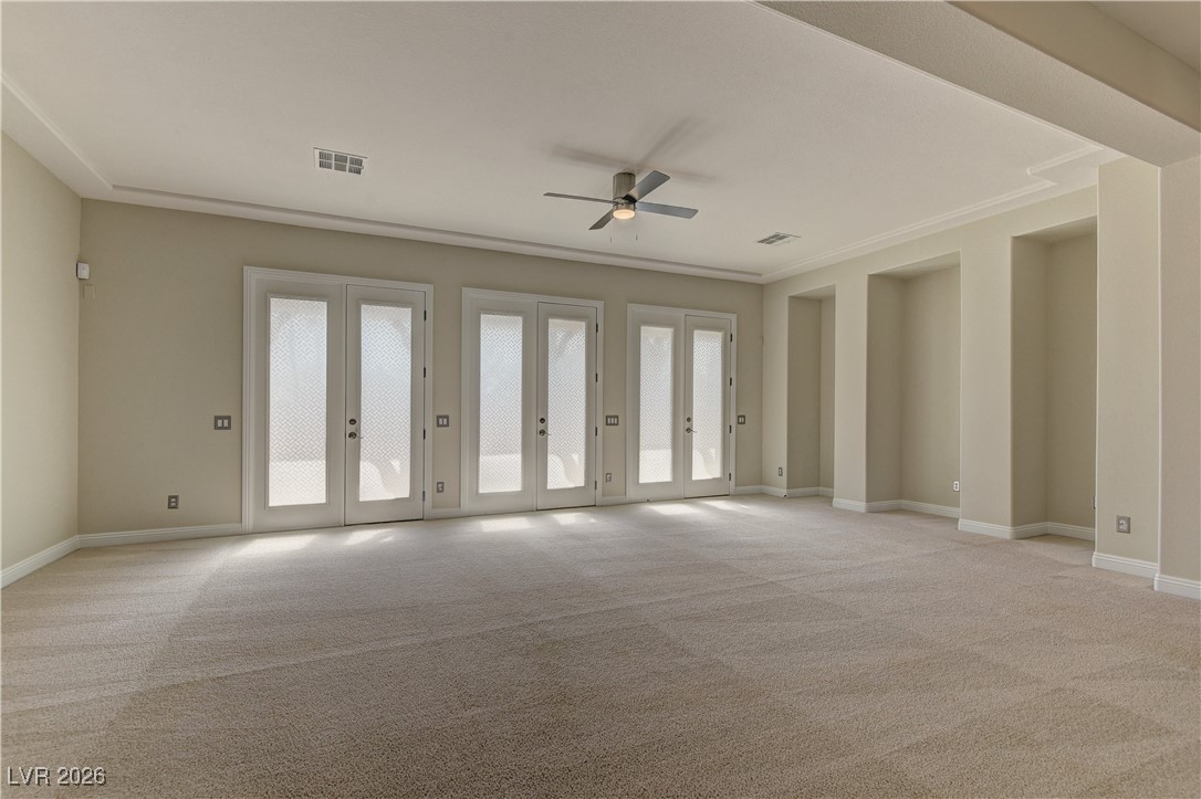 6383 Radiant Rapture Avenue Las Vegas, NV 89131 - Photo 4 of 17 Empty room featuring a ceiling fan and light carpet