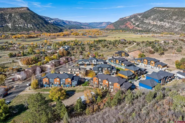 an aerial view of residential houses with outdoor space