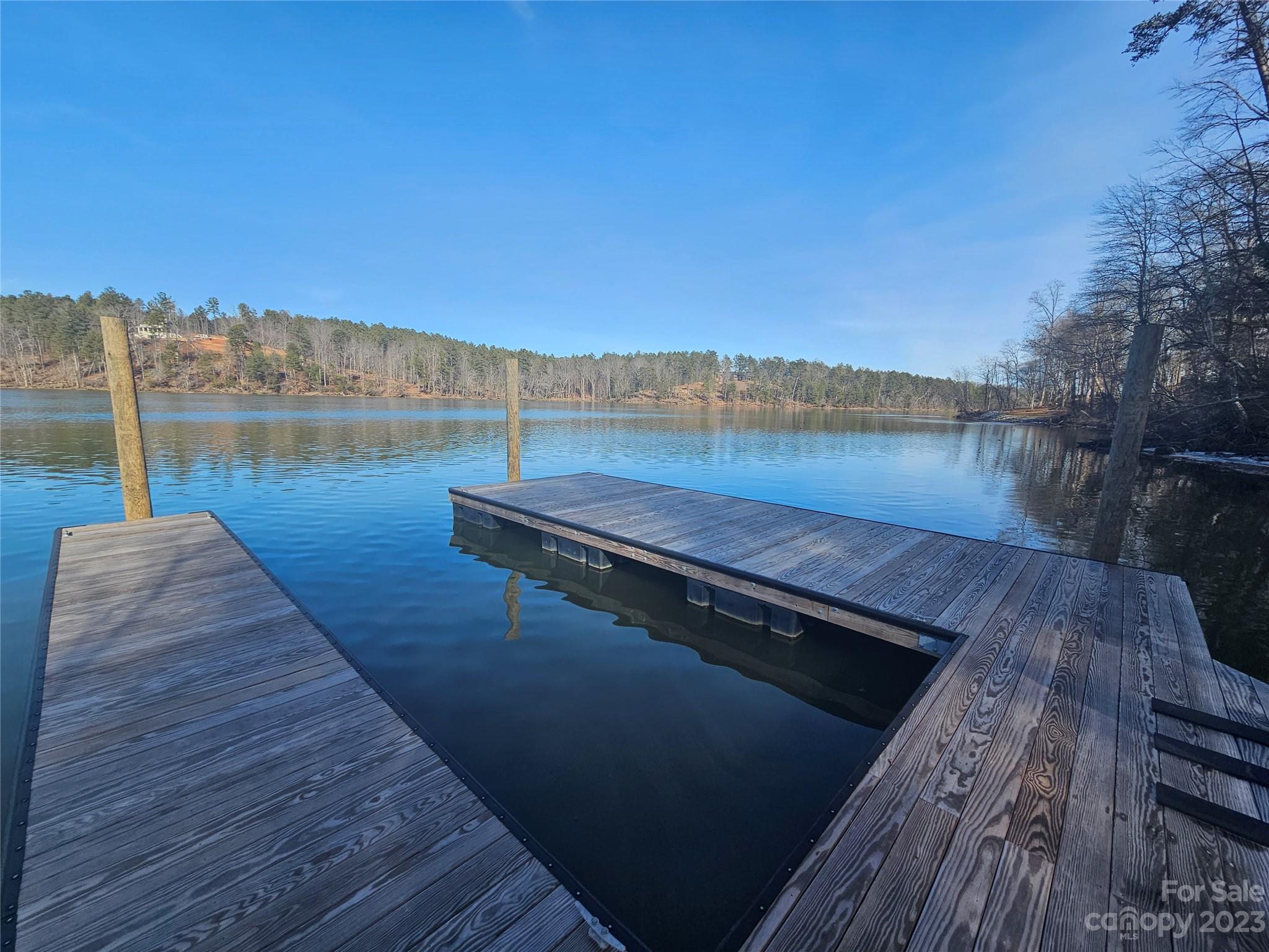 a view of a lake with wooden floor and lake view