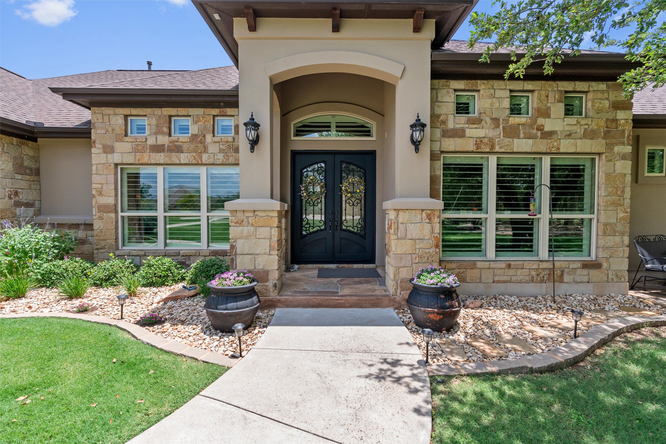 104 Adobe Cove Georgetown, TX 78633 - Photo 1 of 39 Doorway to property with stone siding, french doors, a shingled roof, and a yard