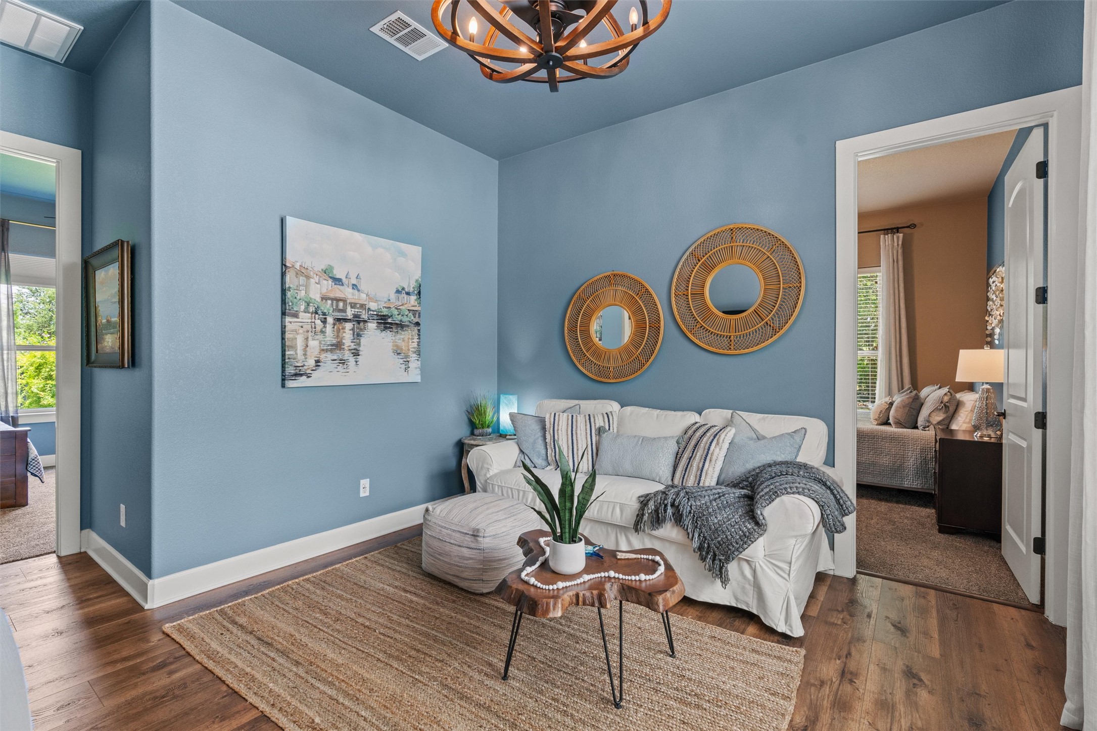 104 Adobe Cove Georgetown, TX 78633 - Photo 16 of 39 Living room featuring healthy amount of natural light, dark wood-style flooring, and suspended lighting