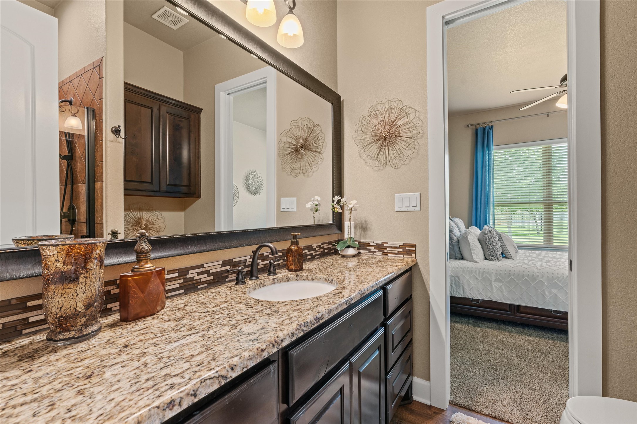 104 Adobe Cove Georgetown, TX 78633 - Photo 18 of 39 Ensuite bathroom featuring vanity, ceiling fan, a shower, and dark colored carpet