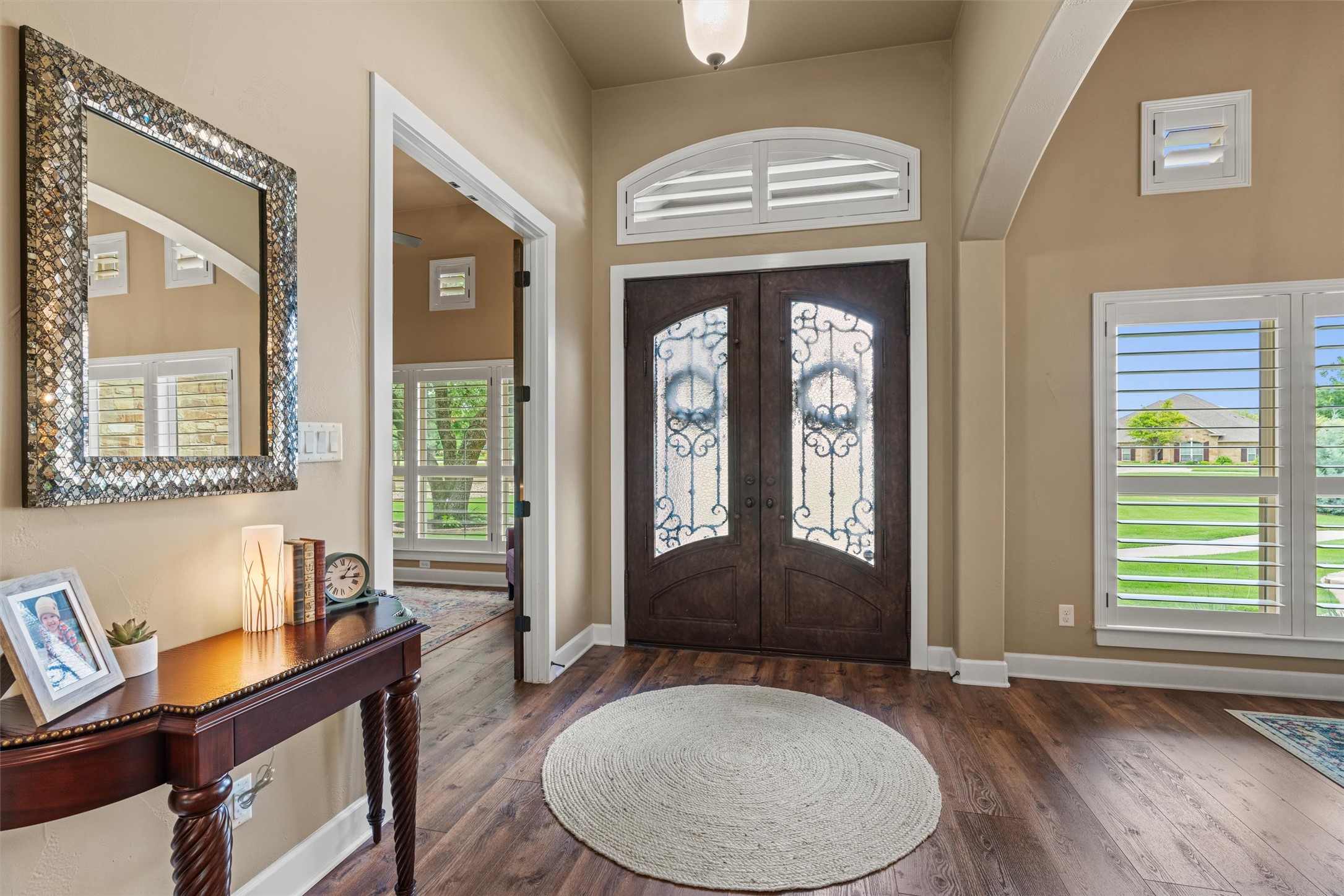 104 Adobe Cove Georgetown, TX 78633 - Photo 3 of 39 Foyer entrance featuring french doors, dark wood-style flooring, arched walkways, and a high ceiling