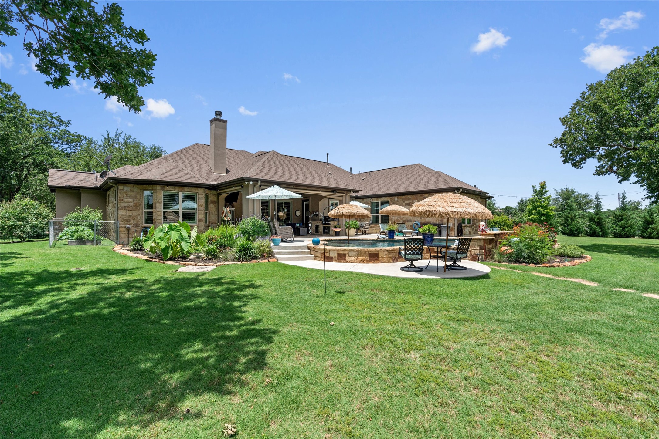 104 Adobe Cove Georgetown, TX 78633 - Photo 31 of 39 Rear view of property with a patio, a yard, a chimney, and an outdoor pool