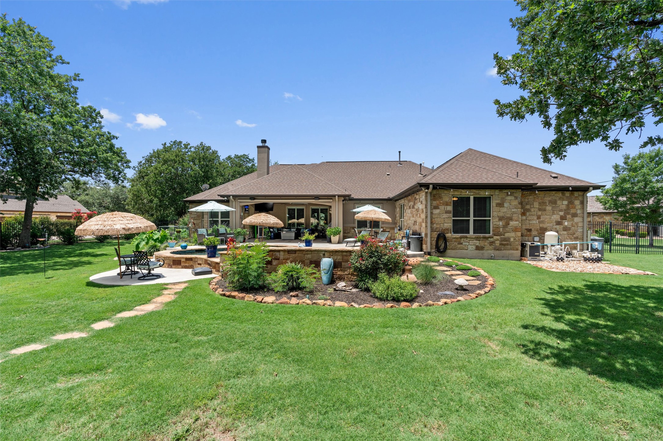 104 Adobe Cove Georgetown, TX 78633 - Photo 32 of 39 Rear view of property featuring a patio area, a chimney, stone siding, an outdoor fire pit, and roof with shingles