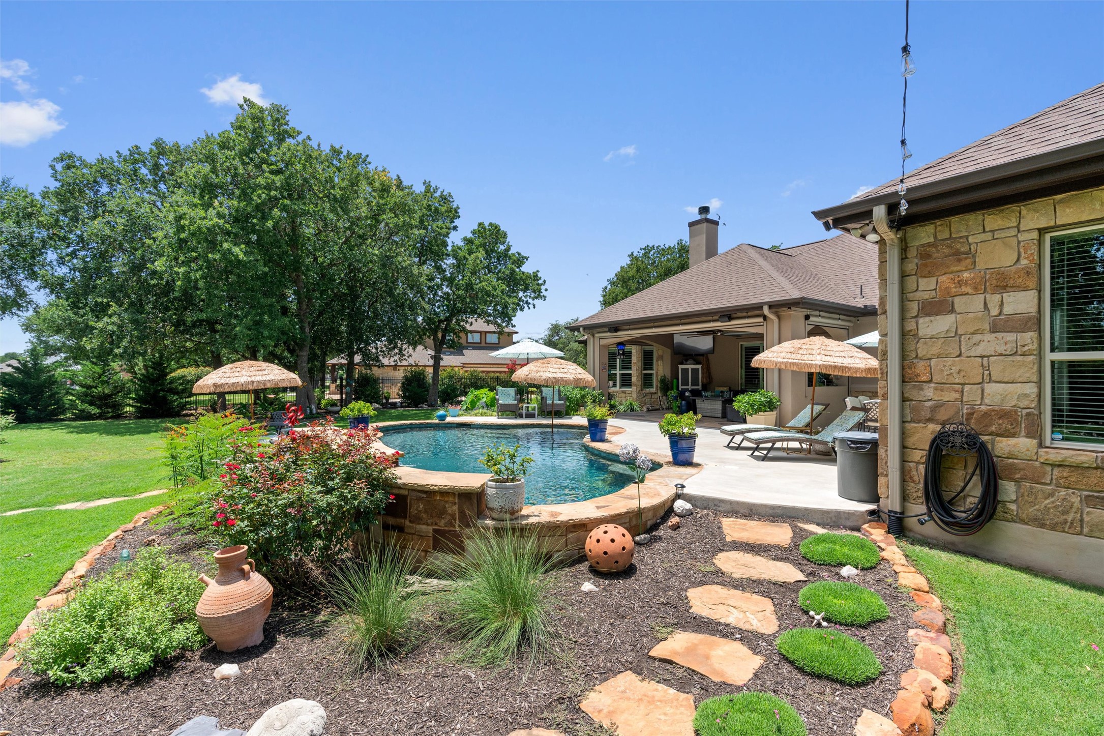 104 Adobe Cove Georgetown, TX 78633 - Photo 33 of 39 Outdoor pool with a patio and a lawn