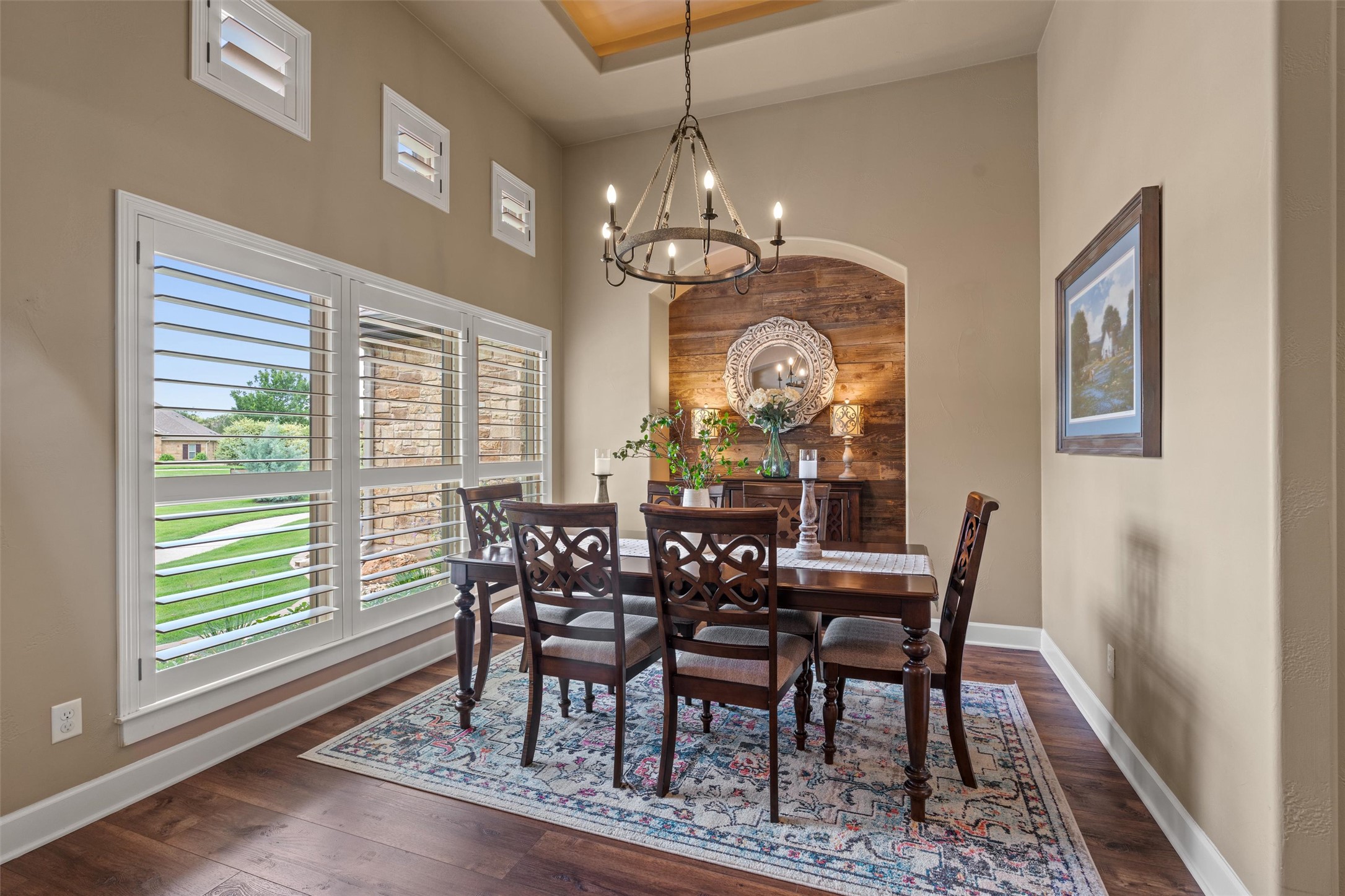 104 Adobe Cove Georgetown, TX 78633 - Photo 5 of 39 Dining room with dark wood-type flooring, a high ceiling, a chandelier, and wood walls