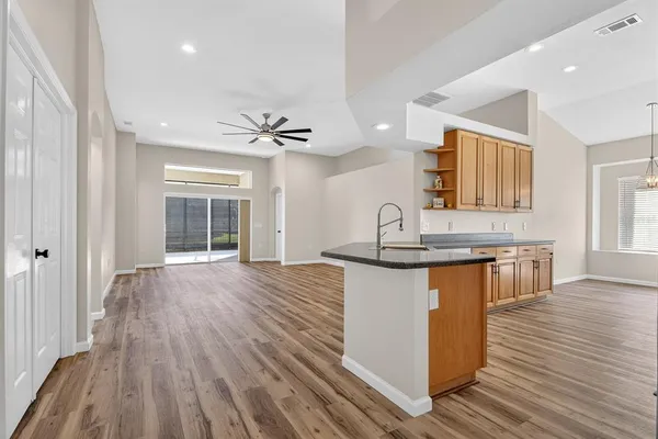 a kitchen with granite countertop a sink and a stove top oven