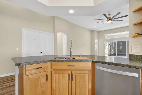a view of a kitchen with a sink stainless steel appliances and cabinets