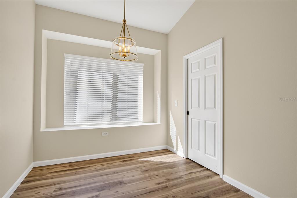 6002 Martinglade Place Lithia, FL 33547 - Photo 17 of 62 a view of an empty room with wooden floor and a window