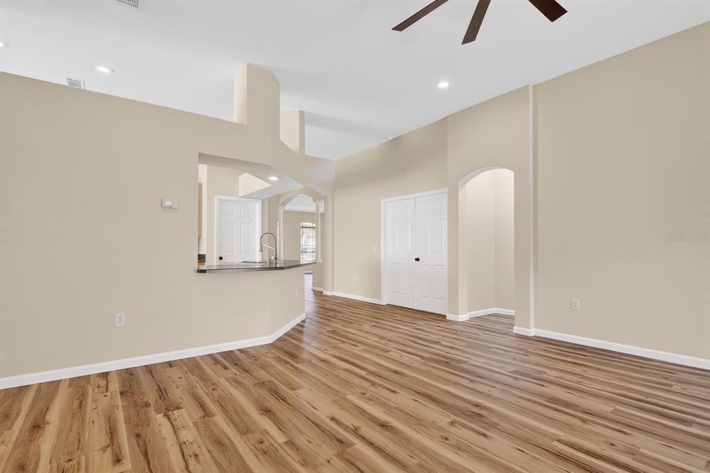 6002 Martinglade Place Lithia, FL 33547 - Photo 19 of 62 a view of an empty room with wooden floor and a window