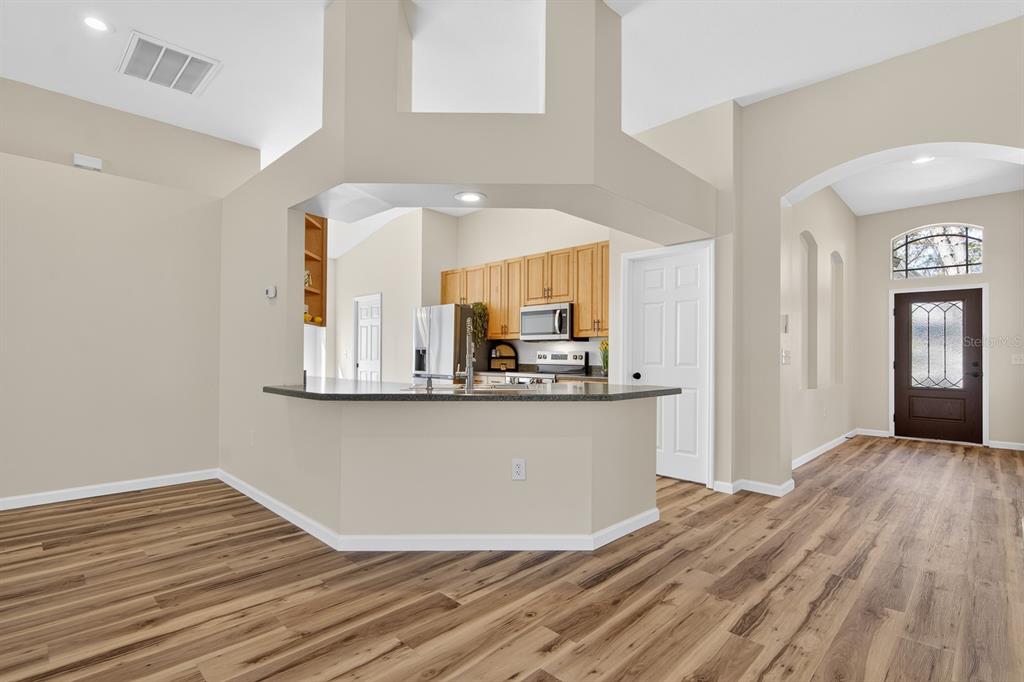6002 Martinglade Place Lithia, FL 33547 - Photo 21 of 62 a view of kitchen and hall with wooden floor