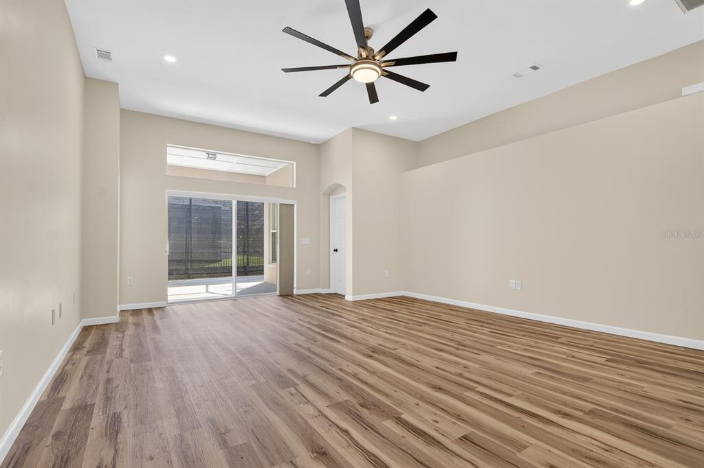 6002 Martinglade Place Lithia, FL 33547 - Photo 23 of 62 wooden floor in an empty room with a window