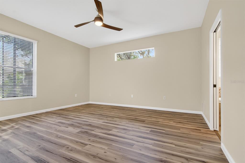 6002 Martinglade Place Lithia, FL 33547 - Photo 25 of 62 a view of an empty room with wooden floor and a window