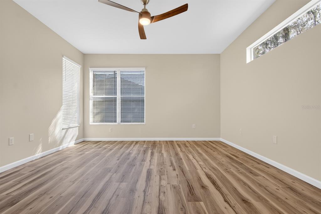 6002 Martinglade Place Lithia, FL 33547 - Photo 26 of 62 a view of an empty room with wooden floor and a window