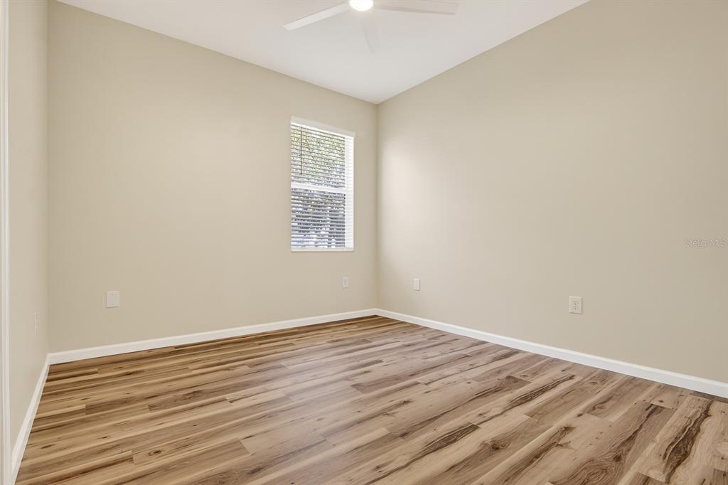 6002 Martinglade Place Lithia, FL 33547 - Photo 28 of 62 an empty room with wooden floor and windows