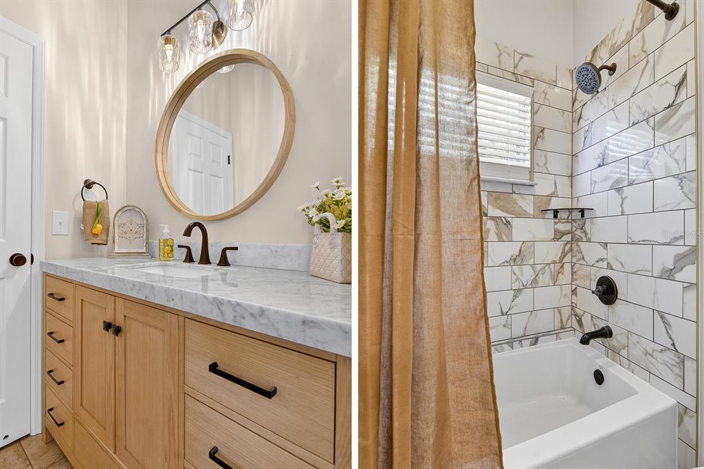 6002 Martinglade Place Lithia, FL 33547 - Photo 32 of 62 a bathroom with a granite countertop sink a mirror and a bathtub