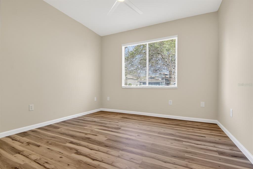 6002 Martinglade Place Lithia, FL 33547 - Photo 33 of 62 an empty room with wooden floor and windows