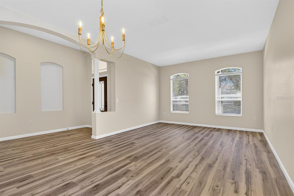 6002 Martinglade Place Lithia, FL 33547 - Photo 4 of 62 a view of an empty room with wooden floor and a window
