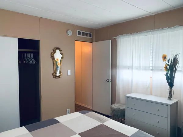 a bedroom with a bed and a dresser in it