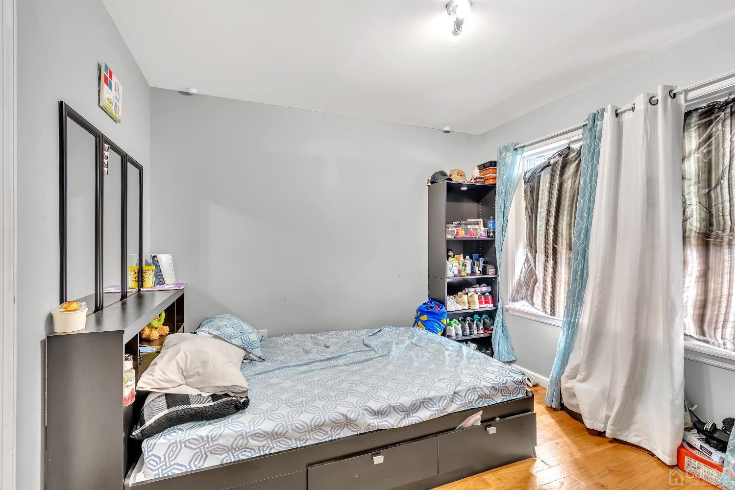 A Wright Place New Brunswick, NJ 08901 - Photo 21 of 34 a bedroom with a bed and a window