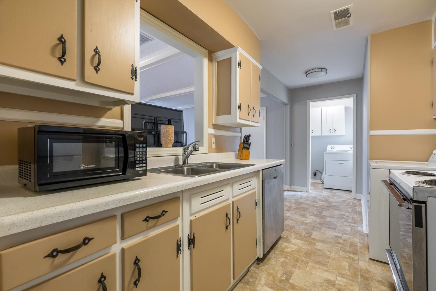 4500 Helene Road Memphis, TN 38117 - Photo 10 of 25 a kitchen with stainless steel appliances kitchen island granite countertop a stove a microwave and a sink