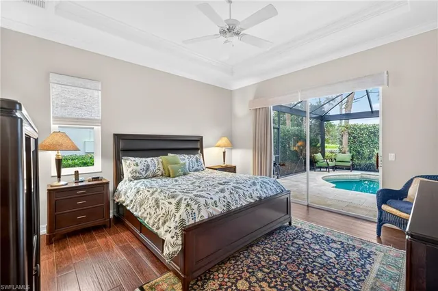 a bedroom with a bed and large windows