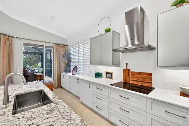 a kitchen with granite countertop a sink stainless steel appliances and cabinets