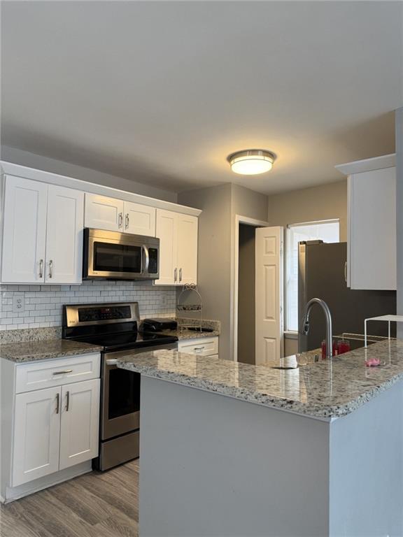 105 Hawkstone Way Alpharetta, GA 30022 - Photo 13 of 23 a kitchen with stainless steel appliances granite countertop a sink and stove top oven