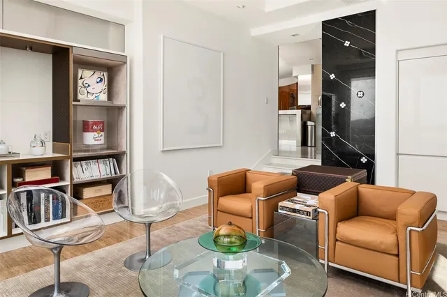 a living room with furniture a rug and a book shelf