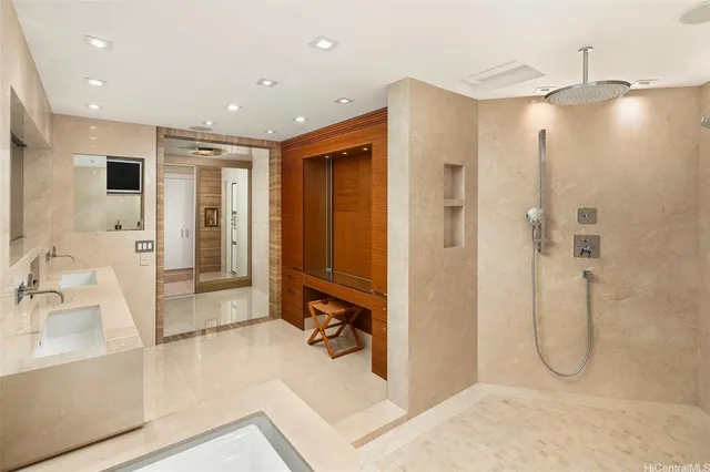 a bathroom with a glass shower door and a sink