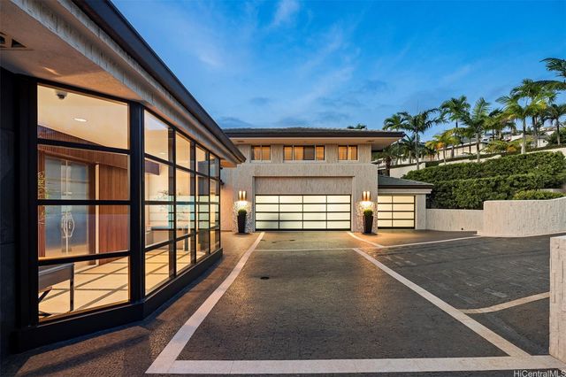 a view of a porch with a floor to ceiling window and potted plants