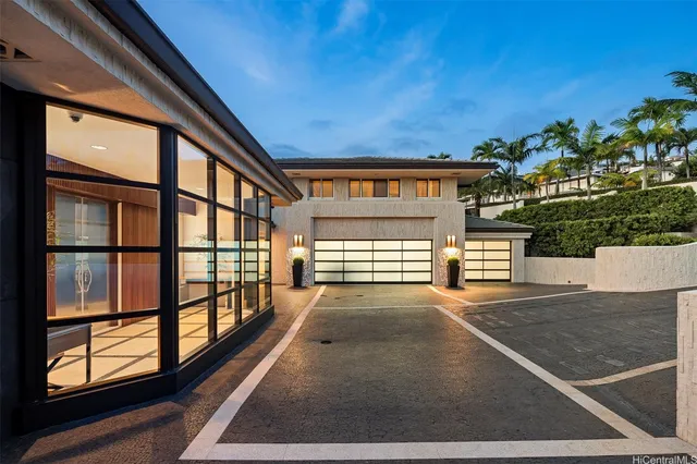 a view of a porch with a floor to ceiling window and potted plants