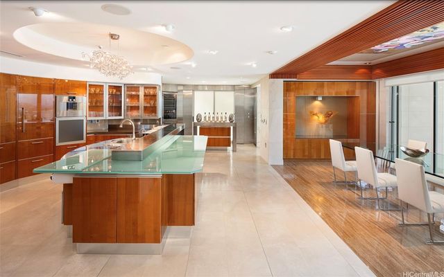 a dining hall with couches a coffee table and chairs with wooden floor