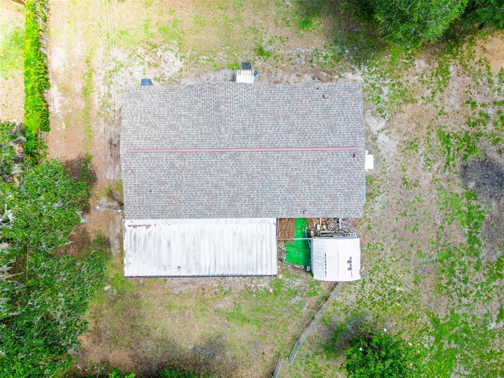 1819 Sinclair Hills Road Lutz, FL 33549 - Photo 9 of 60 an aerial view of a house with a yard and large tree